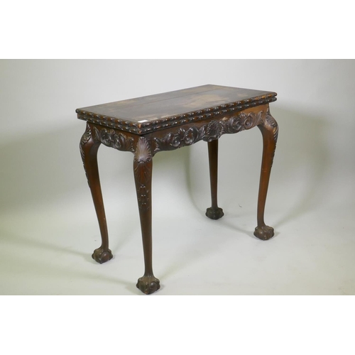 1018 - Chippendale style card table with fold over top and carved decoration, raised on cabriole supports w... 