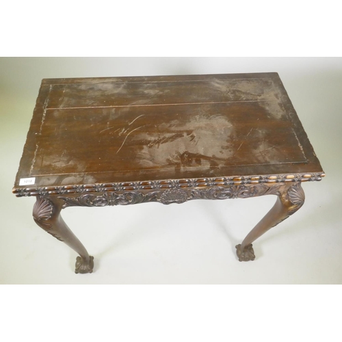 1018 - Chippendale style card table with fold over top and carved decoration, raised on cabriole supports w... 