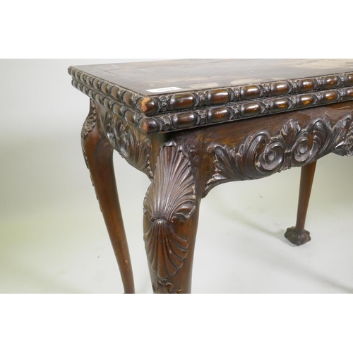 1018 - Chippendale style card table with fold over top and carved decoration, raised on cabriole supports w... 