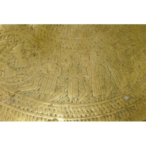 102 - Antique oriental gilt copper tray, the border decorated with a procession of men accompanied by bird... 