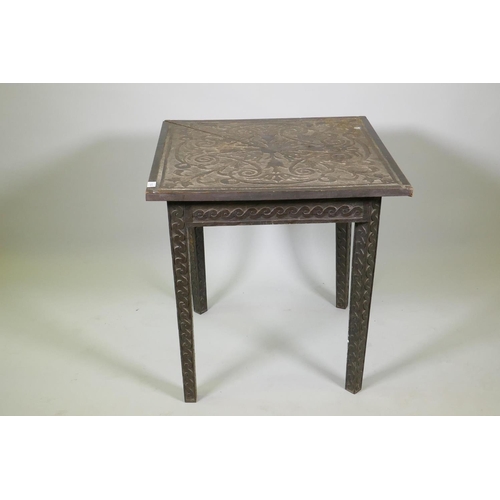 1023 - C19th Flemish oak drop leaf corner table, the frieze and legs carved with a Vitruvian scroll, the to... 