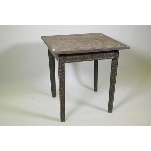 1023 - C19th Flemish oak drop leaf corner table, the frieze and legs carved with a Vitruvian scroll, the to... 