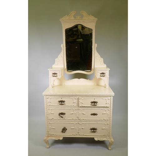 1024 - A Victorian painted pine dressing table with applied composition decoration, the swing mirror with s... 