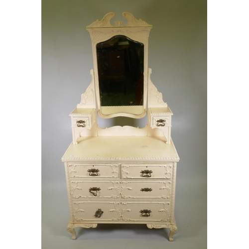 1024 - A Victorian painted pine dressing table with applied composition decoration, the swing mirror with s... 