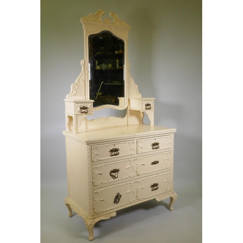 1024 - A Victorian painted pine dressing table with applied composition decoration, the swing mirror with s... 