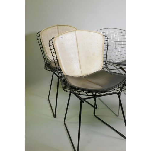 1027 - A pair of Harry Bertoia black painted metal wire chairs and four more polished