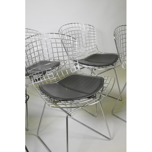 1027 - A pair of Harry Bertoia black painted metal wire chairs and four more polished