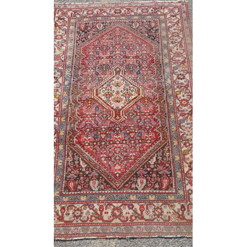 1028 - A Persian rug, medallion design with ivory and green borders, 160 x 104cm