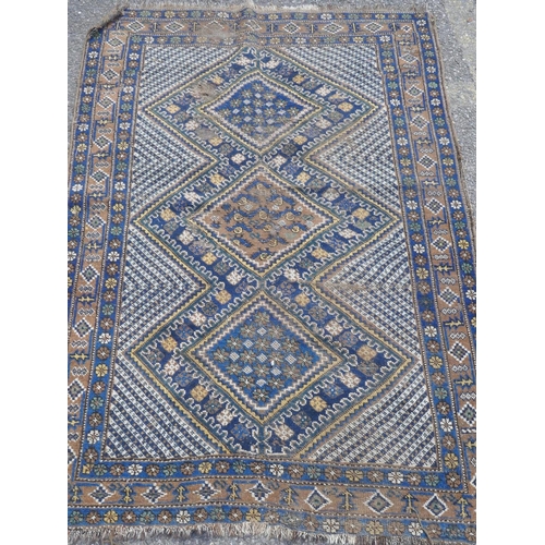 1036 - An oriental Nyriz hand woven wool rug with geometric designs on a blue field, 150 x 108cm