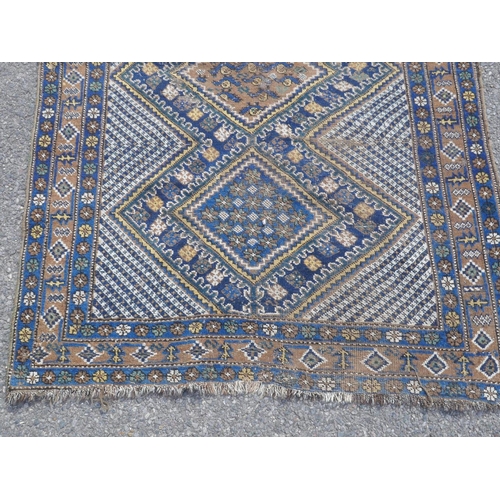 1036 - An oriental Nyriz hand woven wool rug with geometric designs on a blue field, 150 x 108cm