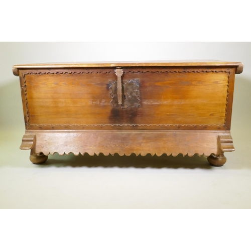 1038 - A C19th Continental pine dower chest with lift up top and decorative shaped apron, raised on turned ... 