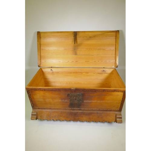 1038 - A C19th Continental pine dower chest with lift up top and decorative shaped apron, raised on turned ... 