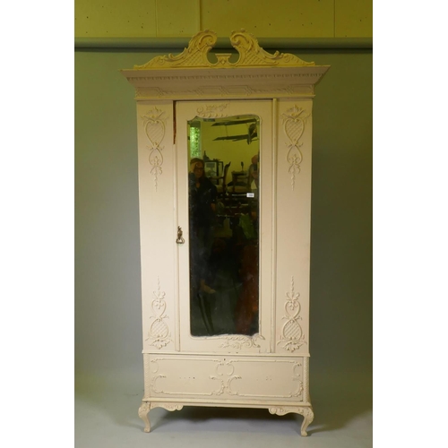 1044 - A Victorian painted pine wardrobe with single mirrored door and applied composition decoration, swan... 