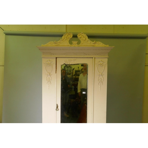 1044 - A Victorian painted pine wardrobe with single mirrored door and applied composition decoration, swan... 