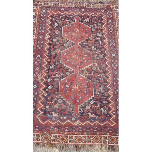 1045 - A Persian khameh rug with geometric design on a red field, 148 x 108cm