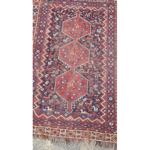 1045 - A Persian khameh rug with geometric design on a red field, 148 x 108cm