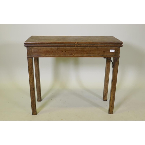 1046 - A Georgian mahogany Chippendale style card table with fold over top, raised on square chamfered supp... 