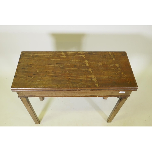 1046 - A Georgian mahogany Chippendale style card table with fold over top, raised on square chamfered supp... 