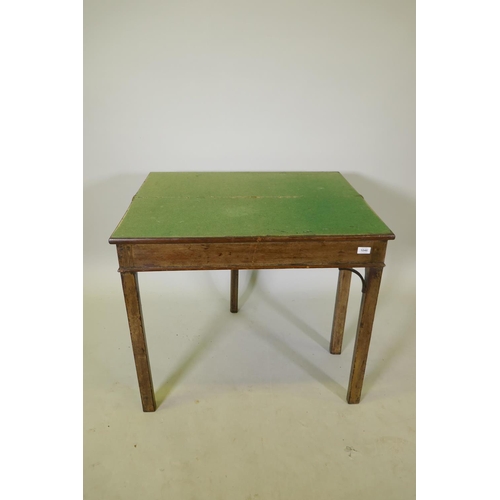 1046 - A Georgian mahogany Chippendale style card table with fold over top, raised on square chamfered supp... 