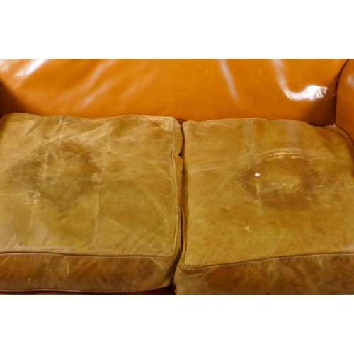 1048 - A pair of Continental antique studded leather two seater settees, with shaped arms and backs, raised... 