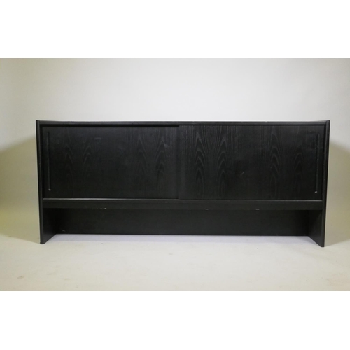 1051 - A Danish black ash sideboard with two slide doors, 152 x 44 x 66cm