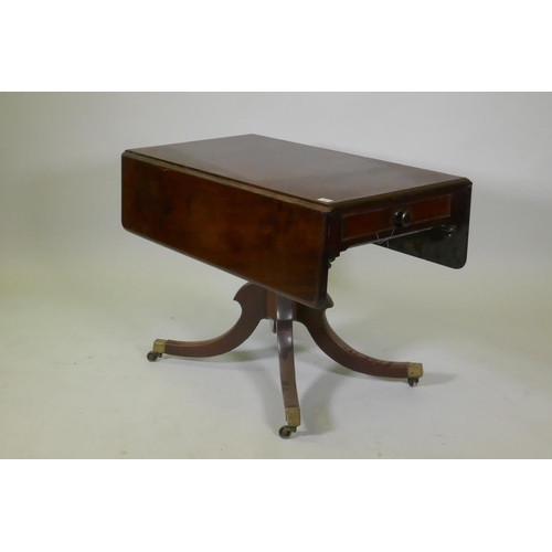 1052 - A Victorian mahogany pembroke table with drawer to each end, raised on a turned column and splay sup... 