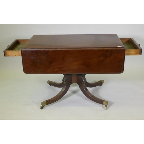 1052 - A Victorian mahogany pembroke table with drawer to each end, raised on a turned column and splay sup... 