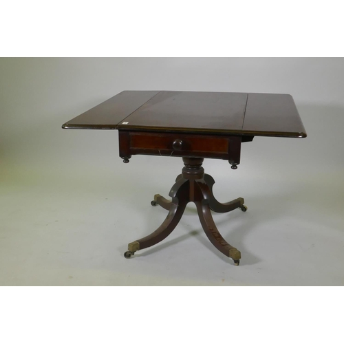 1052 - A Victorian mahogany pembroke table with drawer to each end, raised on a turned column and splay sup... 