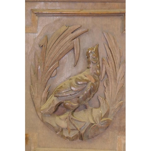 1059 - A pair of C19th Flemish oak panels with carved decoration of game birds, 60 x 64cm