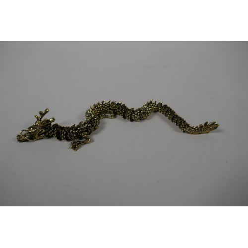 106 - A Japanese Jizai style articulated bronze okimono dragon, 23cm long