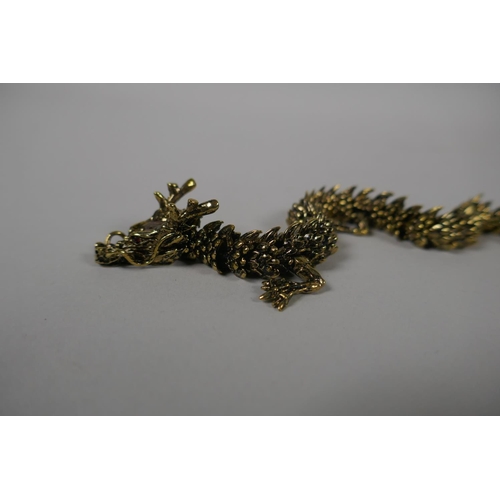 106 - A Japanese Jizai style articulated bronze okimono dragon, 23cm long