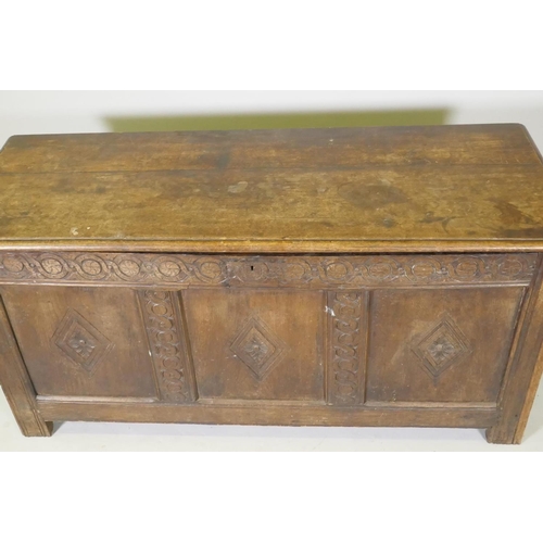 1067 - An C18th three panel coffer with carved frieze and panelled sides, raised on stile supports, AF repa... 