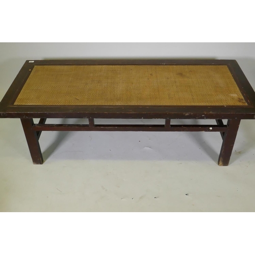 1068 - An antique Chinese hardwood day bed with rattan top, later adaptions, 168 x 72cm, 45cm high