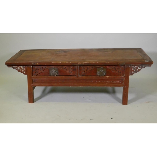 1069 - A Chinese lacquered wood two drawer occasional table with carved details, 154 x 64cm, 49cm high