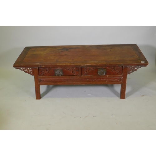 1069 - A Chinese lacquered wood two drawer occasional table with carved details, 154 x 64cm, 49cm high