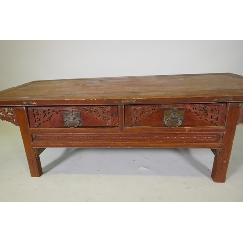 1069 - A Chinese lacquered wood two drawer occasional table with carved details, 154 x 64cm, 49cm high