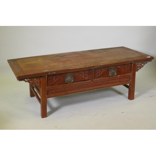 1069 - A Chinese lacquered wood two drawer occasional table with carved details, 154 x 64cm, 49cm high