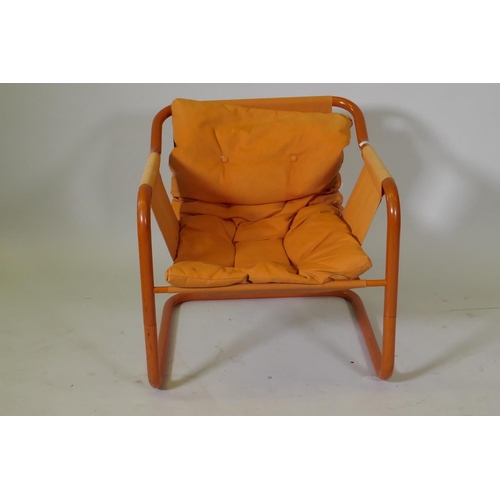 1073 - A vintage Danish tubular steel easy chair with buttoned cushion seat