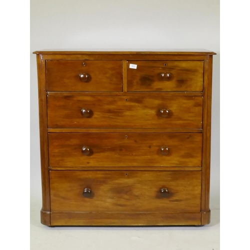 1077 - A Victorian mahogany chest of two over three drawers, with roundel corners and turned wood handles, ... 