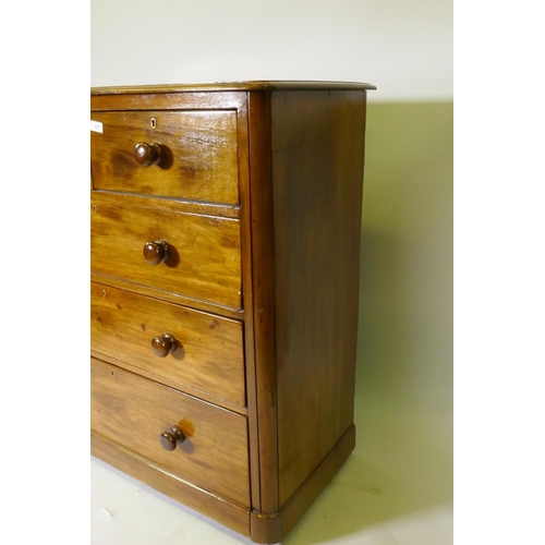 1077 - A Victorian mahogany chest of two over three drawers, with roundel corners and turned wood handles, ... 