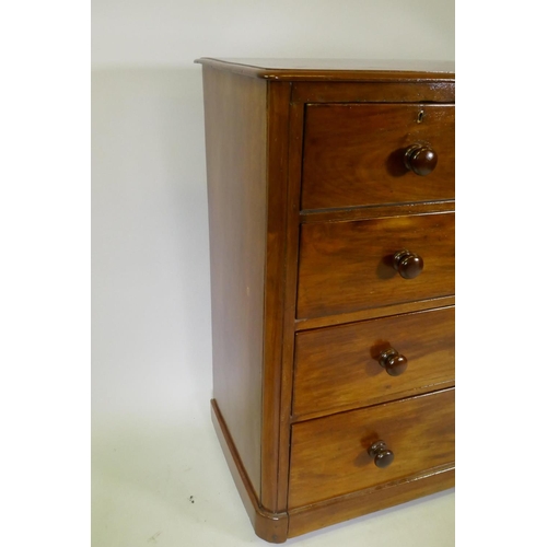 1077 - A Victorian mahogany chest of two over three drawers, with roundel corners and turned wood handles, ... 