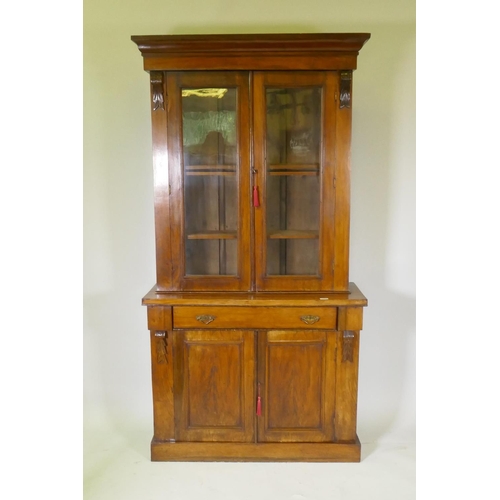 1078 - A Victorian walnut bookcase, the upper section with two glazed doors, the base with single drawer ov... 