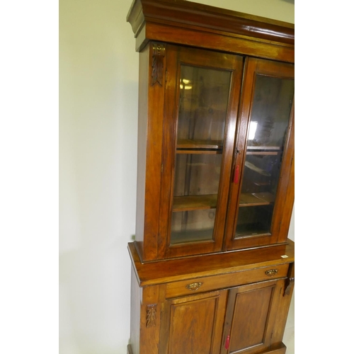 1078 - A Victorian walnut bookcase, the upper section with two glazed doors, the base with single drawer ov... 