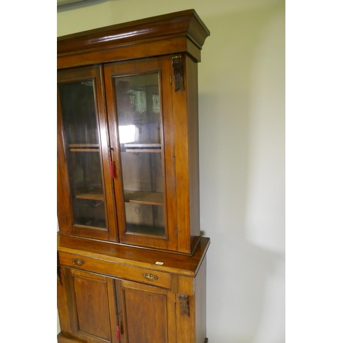 1078 - A Victorian walnut bookcase, the upper section with two glazed doors, the base with single drawer ov... 