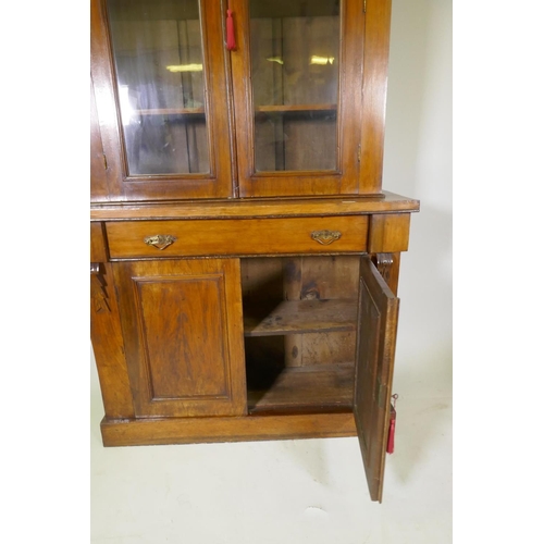 1078 - A Victorian walnut bookcase, the upper section with two glazed doors, the base with single drawer ov... 