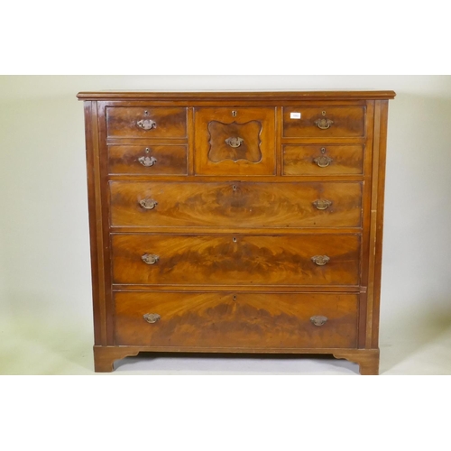 1082 - A Victorian figured mahogany chest with central hat drawer flanked by three drawers over three long ... 