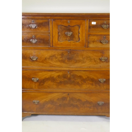 1082 - A Victorian figured mahogany chest with central hat drawer flanked by three drawers over three long ... 