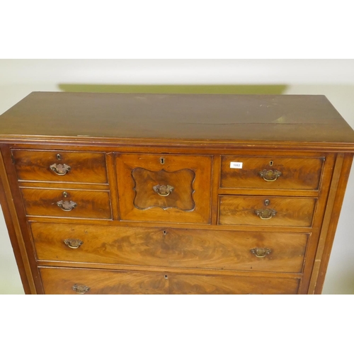 1082 - A Victorian figured mahogany chest with central hat drawer flanked by three drawers over three long ... 