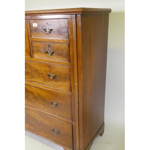 1082 - A Victorian figured mahogany chest with central hat drawer flanked by three drawers over three long ... 