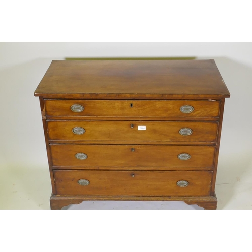 1084 - A Georgian mahogany chest of four long drawers with cockbeaded fronts, oak linings and brass plate h... 